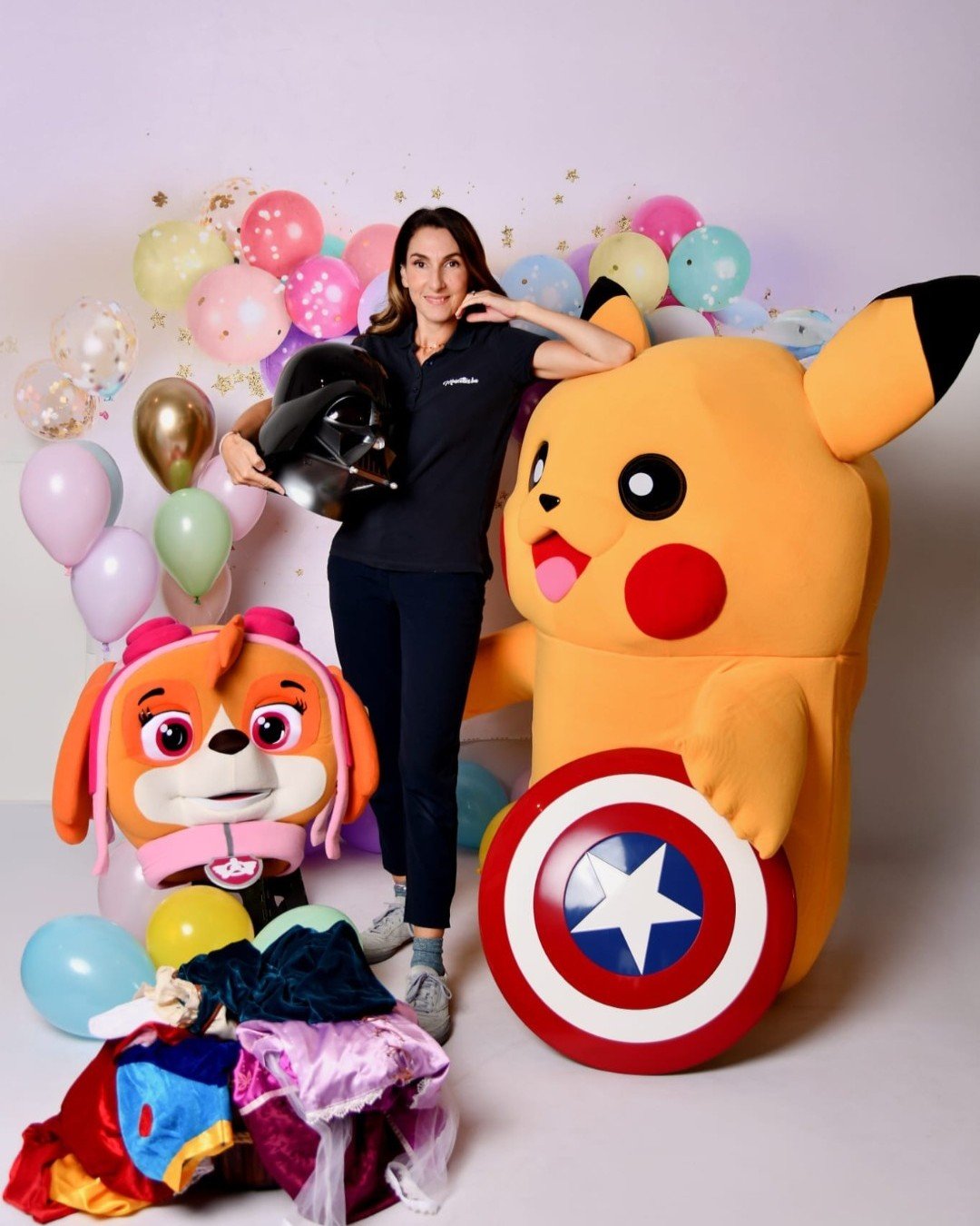 Animatrice Mascottes-ba entourée de mascottes et de ballons pour un anniversaire